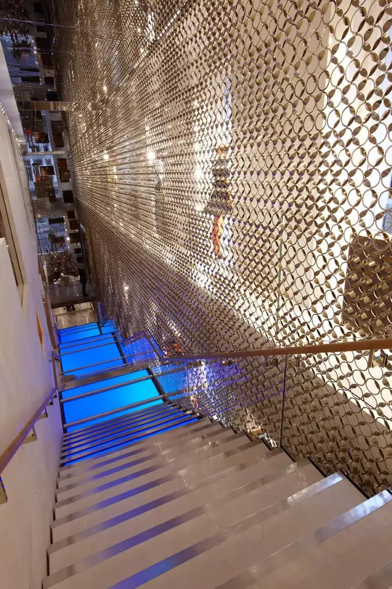 Gold architectural screen beside a feature staircase