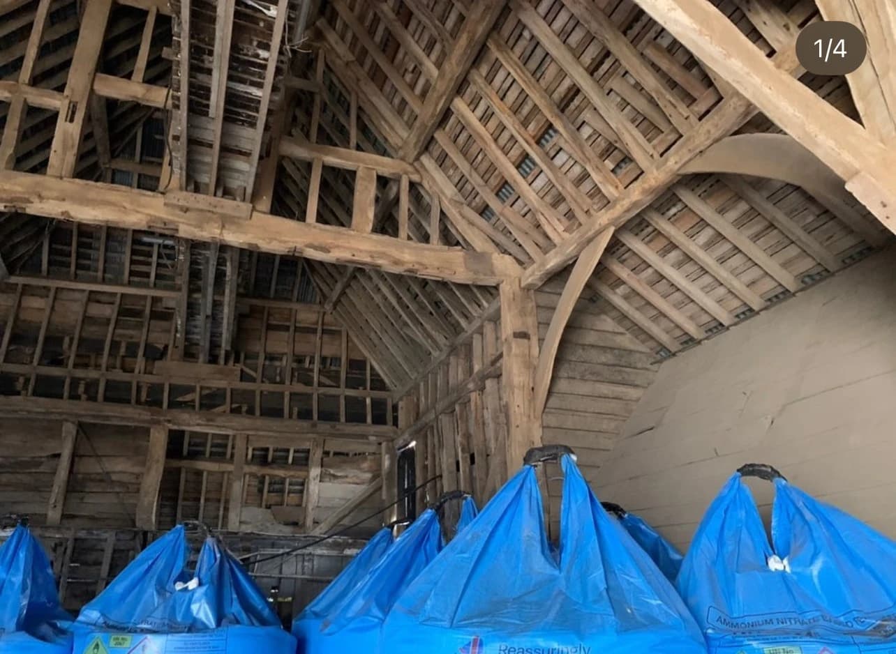 New structural plinth supporting the historic barn frame